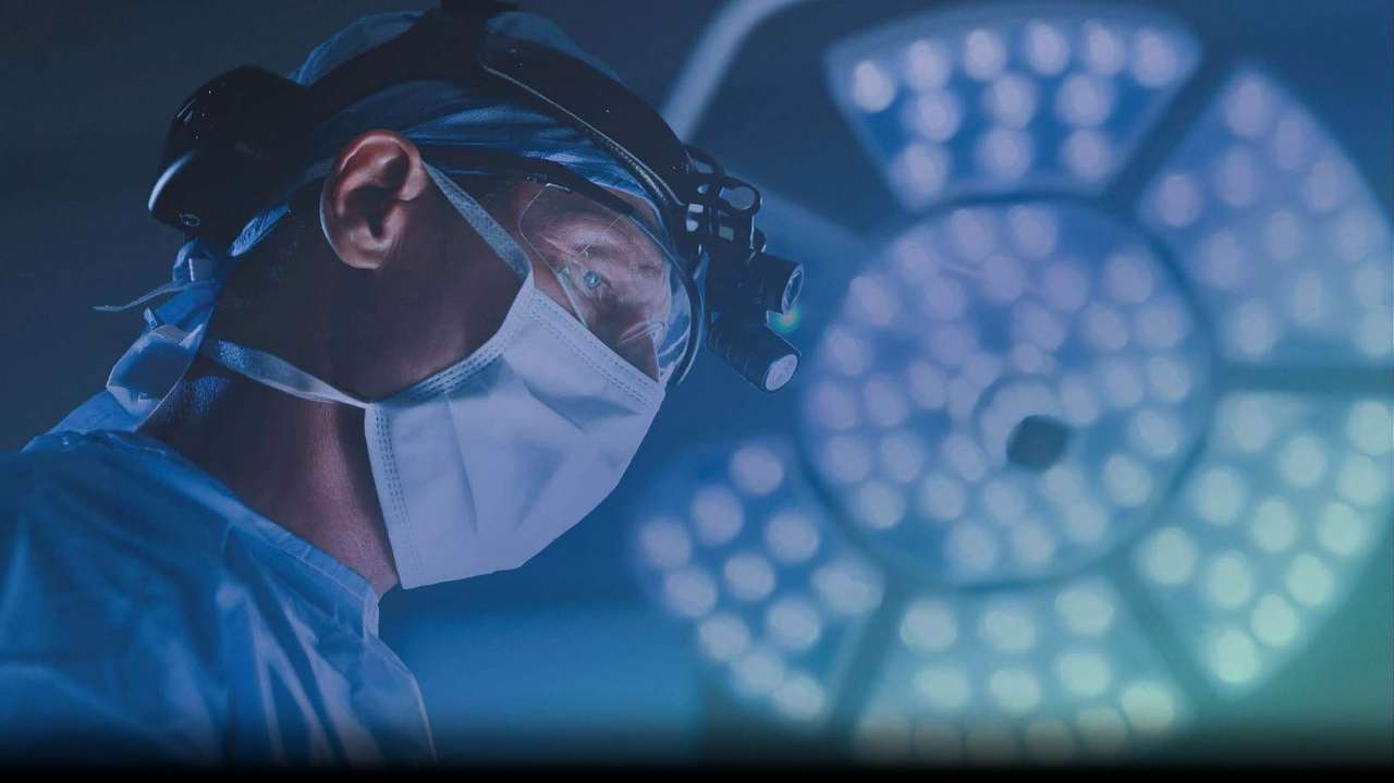 Covenant Health surgeon in the operating room under surgical lights