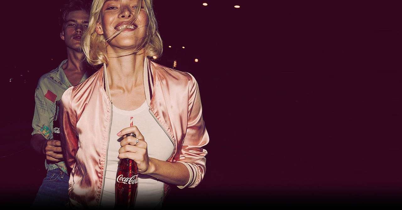 Coca-Cola Journey campaign photography, a couple at night holding Coca-Cola bottles