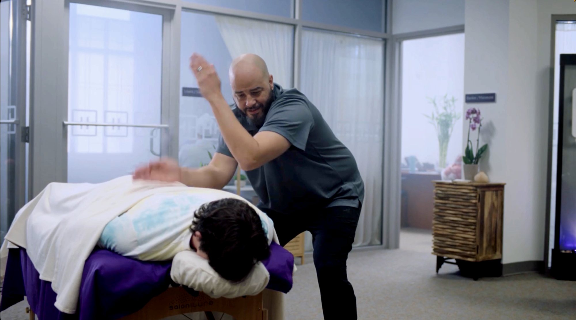 A masseuse mid chop on a client at a spa, a scene from The Care Inventionist social series